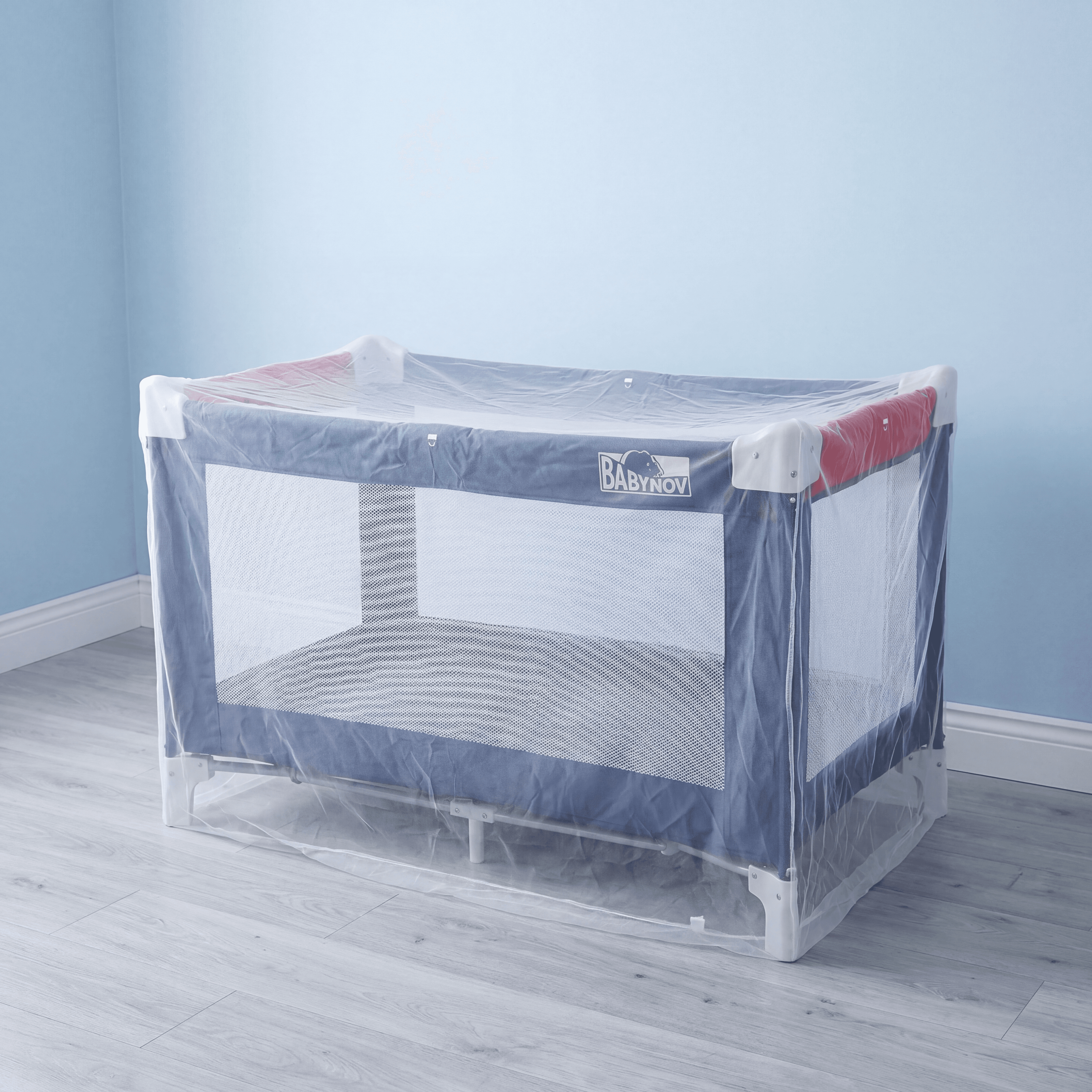 Mosticare Bambino Dorme WHO-prequalified cot mosquito net hung over a European cot in a bright, minimalist nursery.