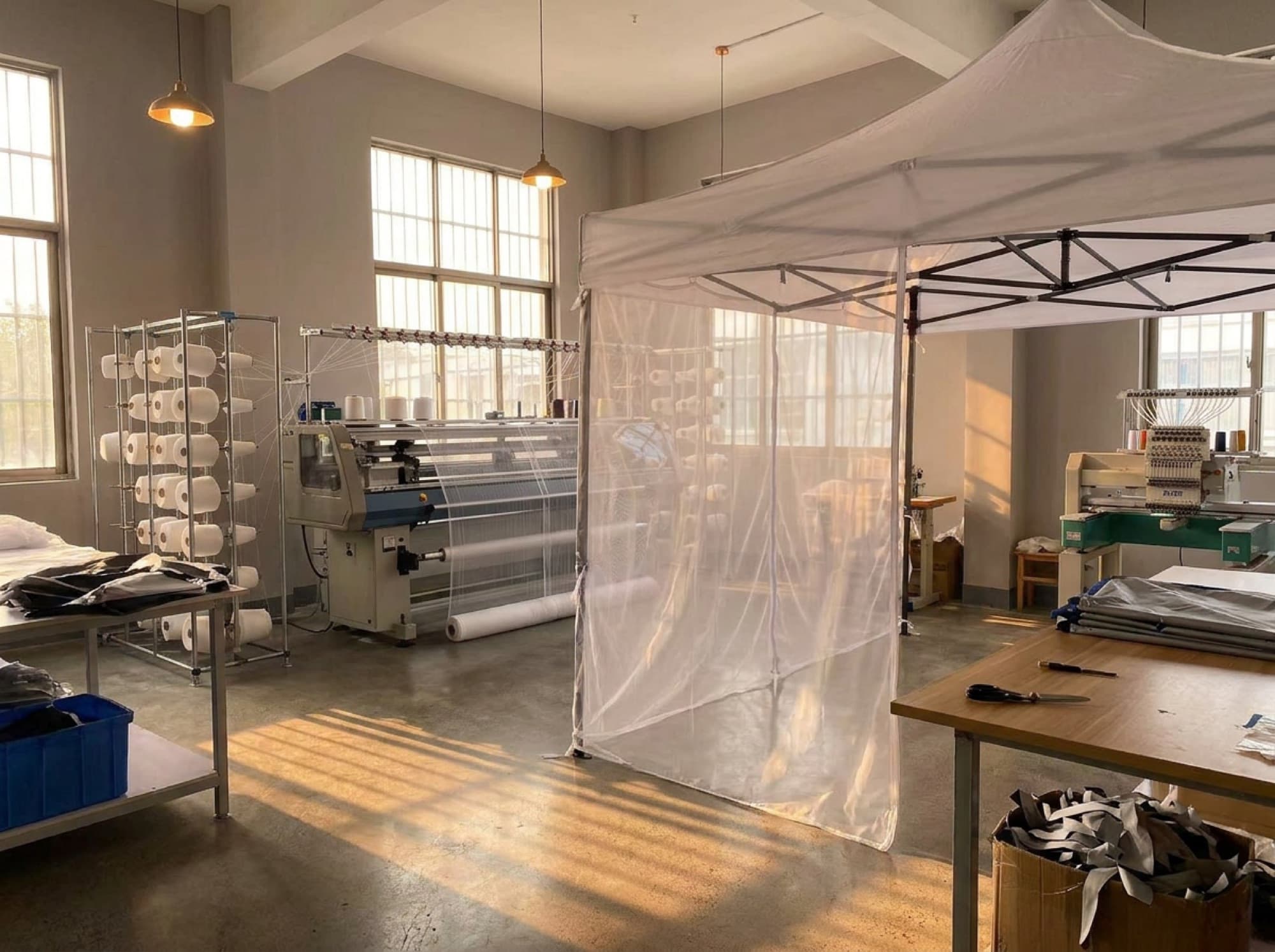 Inside the Mosticare facility — looms and mesh in daylight